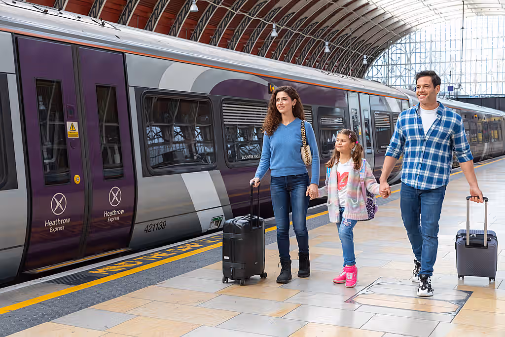 A family of three about to travel on the Heathrow Express